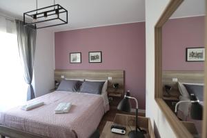 A bed or beds in a room at AnGiò holiday rooms