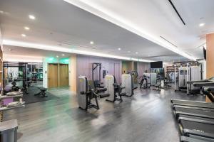 a gym with treadmills and machines in a room at Suites at SLS Lux Brickell managed by CE in Miami