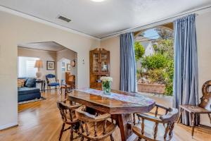 a living room with a wooden table and chairs at Cedar Oasis in Ventura