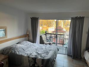 a bedroom with a bed and a view of a balcony at Mzingazi waterfront in Richards Bay