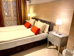 a bedroom with a bed with orange and white pillows at Schiller in Munich