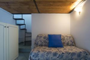 um quarto com uma cadeira e uma almofada azul em B&B Viacampo6 em Atrani