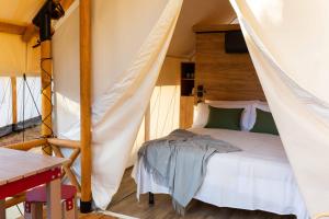 a bedroom with a bed in a tent at wecamp Cabo de Gata in Las Negras