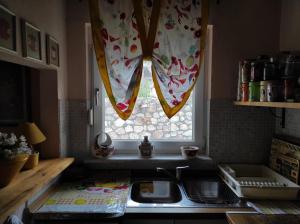 a kitchen with a sink and a window at Countryside Cottage with Garden & Lake View in Peraía