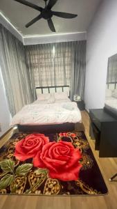 a bedroom with a bed with red roses on a rug at MAYEA Homestay in Sandakan