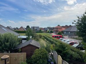 a residential neighborhood with cars parked in a parking lot at Moderne Ferienwohnung in Spaden / Wasserski / Badesee in Schiffdorf