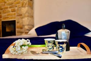 a wooden table with a tray with a tea set on it at La Petite Maison in Pietrapertosa