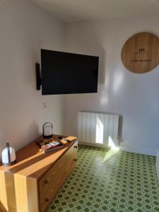a living room with a flat screen tv on the wall at La Fruitière in Chaudenay