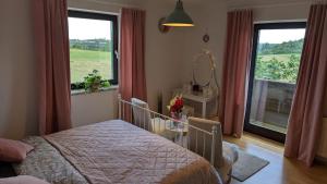 a bedroom with a bed and a large window at Ursteirerhof - Familie Kerschbaumer in Palsdorf