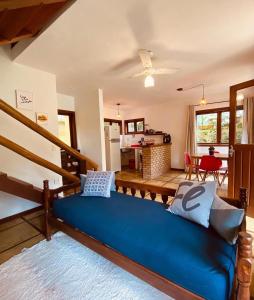 a large blue couch in a living room at Maui Suítes e Chalés in Arraial d'Ajuda