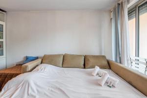 a white bed with two pillows on top of it at Appartement Bréguières - Welkeys in Antibes