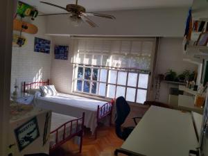 a small room with a bed and a window at Olivos, Habitaciones en Simpatico Duplex in Olivos