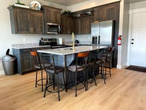 a kitchen with a island with bar stools at Lovely Condo! W/ free recreational vehicle parking in Garden City +5 photos