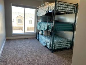 a room with bunk beds in a room with a window at Lovely Condo! W/ free recreational vehicle parking in Garden City