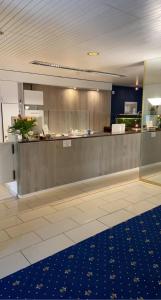 eine große Küche mit einer Theke in einem Gebäude in der Unterkunft Park - Hotel Inseli in Romanshorn