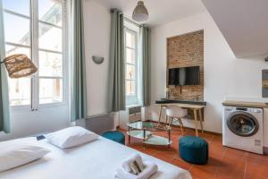 a bedroom with a bed and a washer and dryer at Superb apartment located on the main square - Toulouse - Welkeys in Toulouse