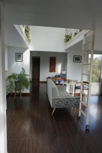 a living room with a staircase and a couch at Casa Towanda in San Carlos de Bariloche