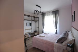 A bed or beds in a room at AnGiò holiday rooms