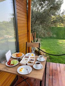 a table with breakfast food on a porch at Tiny Mini House in Dalaman