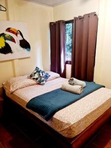 1 cama con 2 toallas en un dormitorio en Jungle Beach Bungalow with AC & Fiber optic, en Puerto Viejo