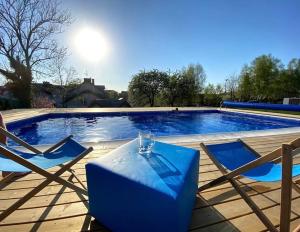 a blue table and chairs next to a swimming pool at Rudnik-apartamenty z basenem, sauną i banią in Władysławowo