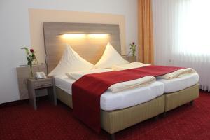 Postel nebo postele na pokoji v ubytování Hotel Bügener