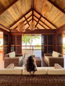 a little girl sitting on a couch in a living room at Irana Pacific Hotel in Nuquí