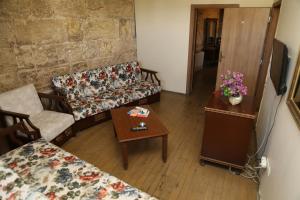 a living room with two couches and a table at KALE EVİ BUTİK OTEL in Şahinbey