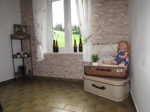 Ein kleines Mädchen, das auf einem Koffer sitzt. in der Unterkunft Bachhäusl in Hof bei Salzburg