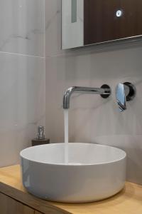 a sink in a bathroom with a faucet at 2 Bedroom condo with dream balcony in Athens