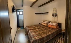 Un dormitorio con una cama con una manta. en Gospodaria Klaus en Rozavlea