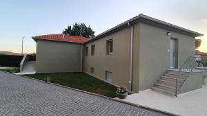 a house with a staircase in front of it at Barrio Apartments in Amares