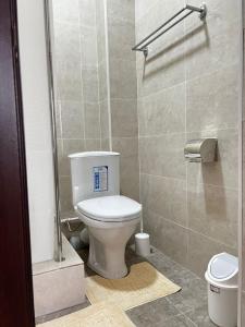 a bathroom with a toilet and a shower at Meiman House close to Asia Mall in Bishkek