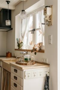 a kitchen with a sink and a window at Logement Cornelia - Tholen, Zeeland in Tholen +14 photos
