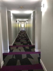 a hallway with a long corridor with purple and white walls at The Spot at Porpoise Bay in Sechelt