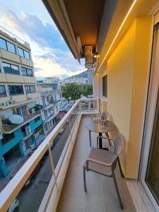 a balcony with a table and chairs on a building at Pleasant Stay in Kavala