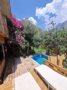 a swimming pool in a yard with flowers at Kabak Lost Forest VİLLA in Kızılcakaya