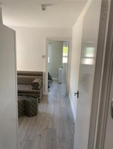 a hallway of a living room with a wooden floor at Beautiful First Floor one bedroom apartment B Walthamstow in London