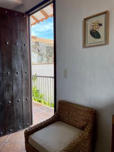 a room with a chair and a door to a balcony at Hotel Boutique Posada Las Trampas in Honda