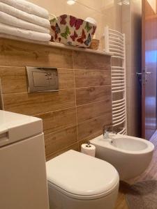 a bathroom with a white toilet and a sink at Apartment Ajna in Sarajevo