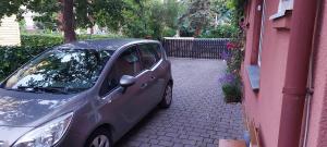 a small car parked next to a building at Studentiški apartamentai Palangoje in Palanga