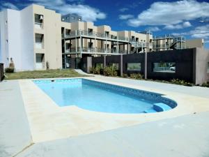 a large swimming pool in front of a building at Nuevos Aires in Las Grutas