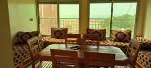 a room with a table and chairs and a couch at Dar Assalam 1 in Oualidia