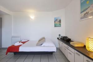 Schlafzimmer mit einem Bett mit weißer Bettwäsche und einer Theke in der Unterkunft Wonderful apartment with direct access to the beach - Bidart - Welkeys in Bidart
