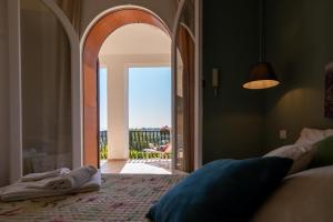 a bedroom with an open door to a patio at Casa Vacanze Baia di Guidaloca in Castellammare del Golfo