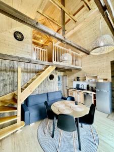 a kitchen and dining room with a table and chairs at Wypoczynek pod Lipami in Ruciane-Nida
