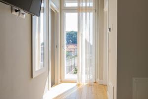an empty hallway with a large window with a view at B&B Margante in Somma Lombardo
