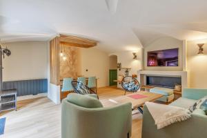 a living room with a couch and a table at Appartement - Château de Beuzeval - Welkeys in Houlgate