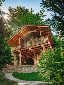 a tree house with a wrap around deck at Tworzówka - Ekskluzywne Domy w górach in Żabnica