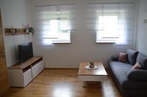 a living room with a couch and a coffee table at Zimmervermietung Familie Glatz in Möderbrugg